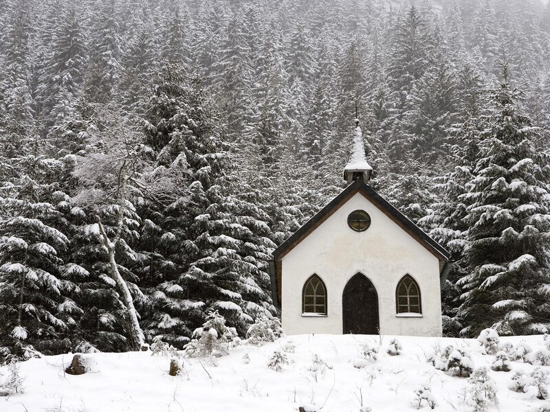 Snowy chapel in forest