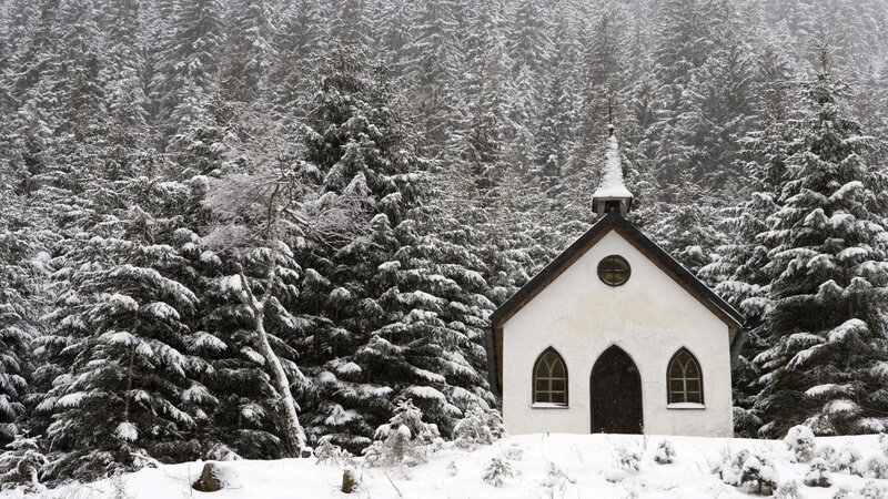 Snowy chapel in forest