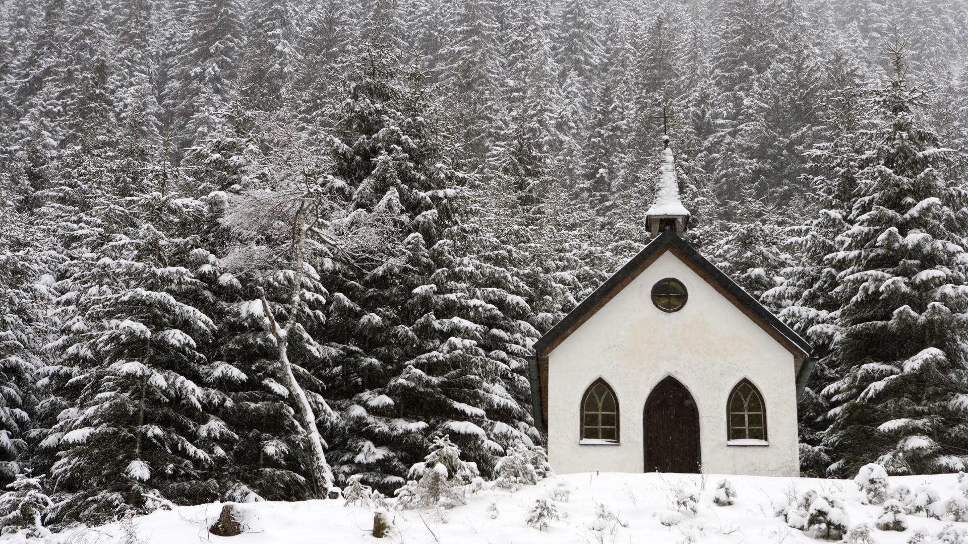 Snowy chapel in forest