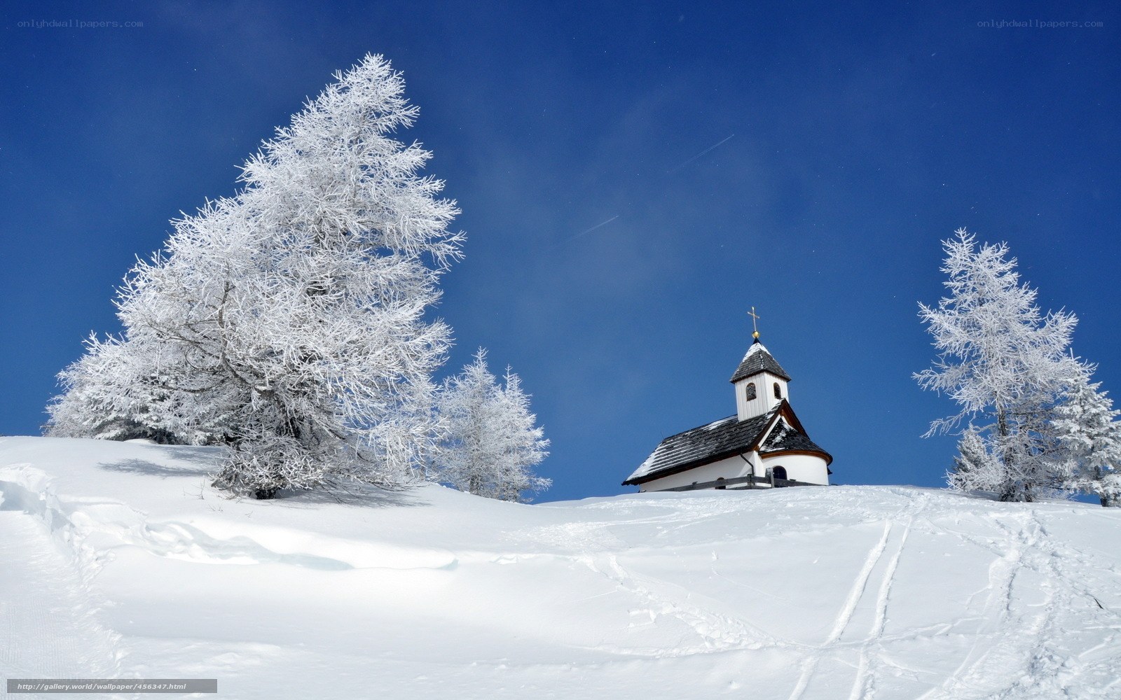 Snowy chapel on a hill