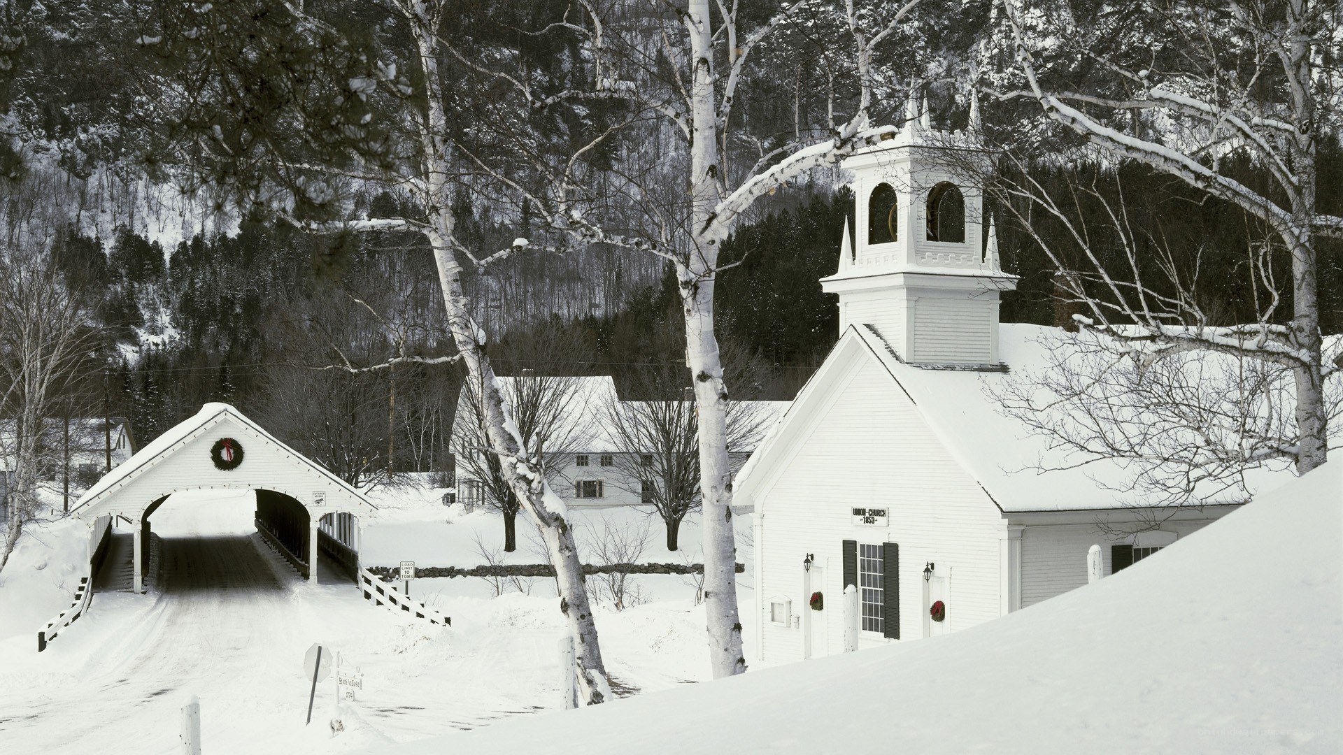 Snowy church and covered bridge