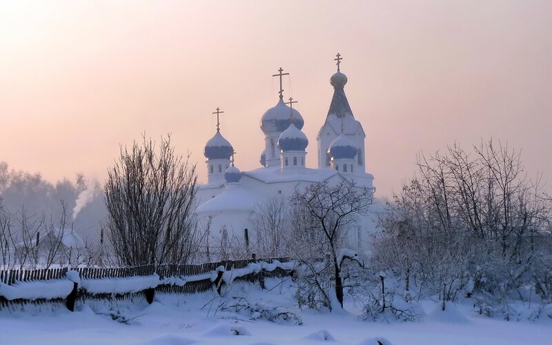 Snowy church at dawn