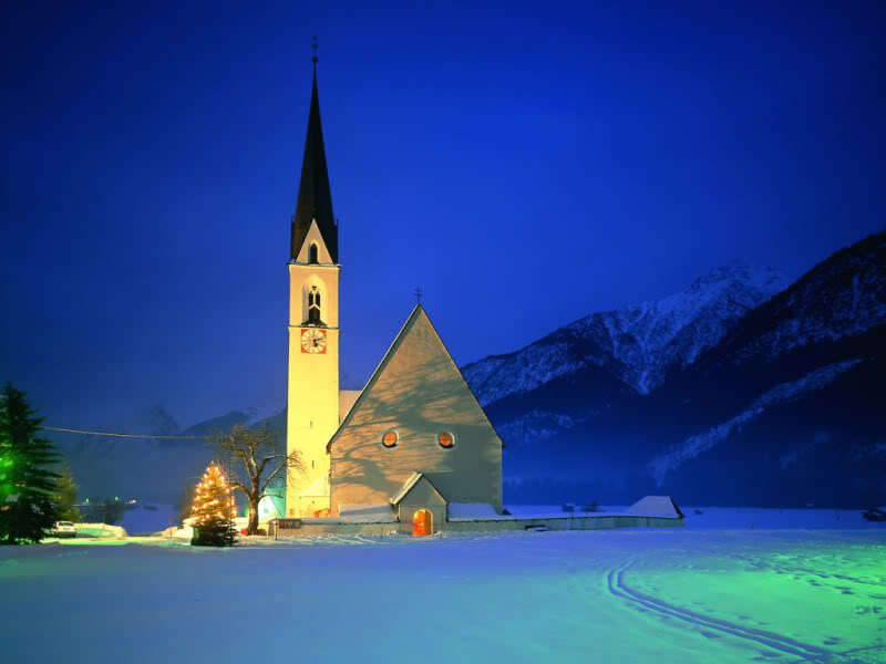 snowy church at night
