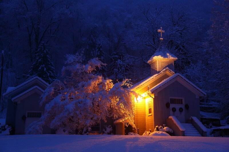 Snowy church at night