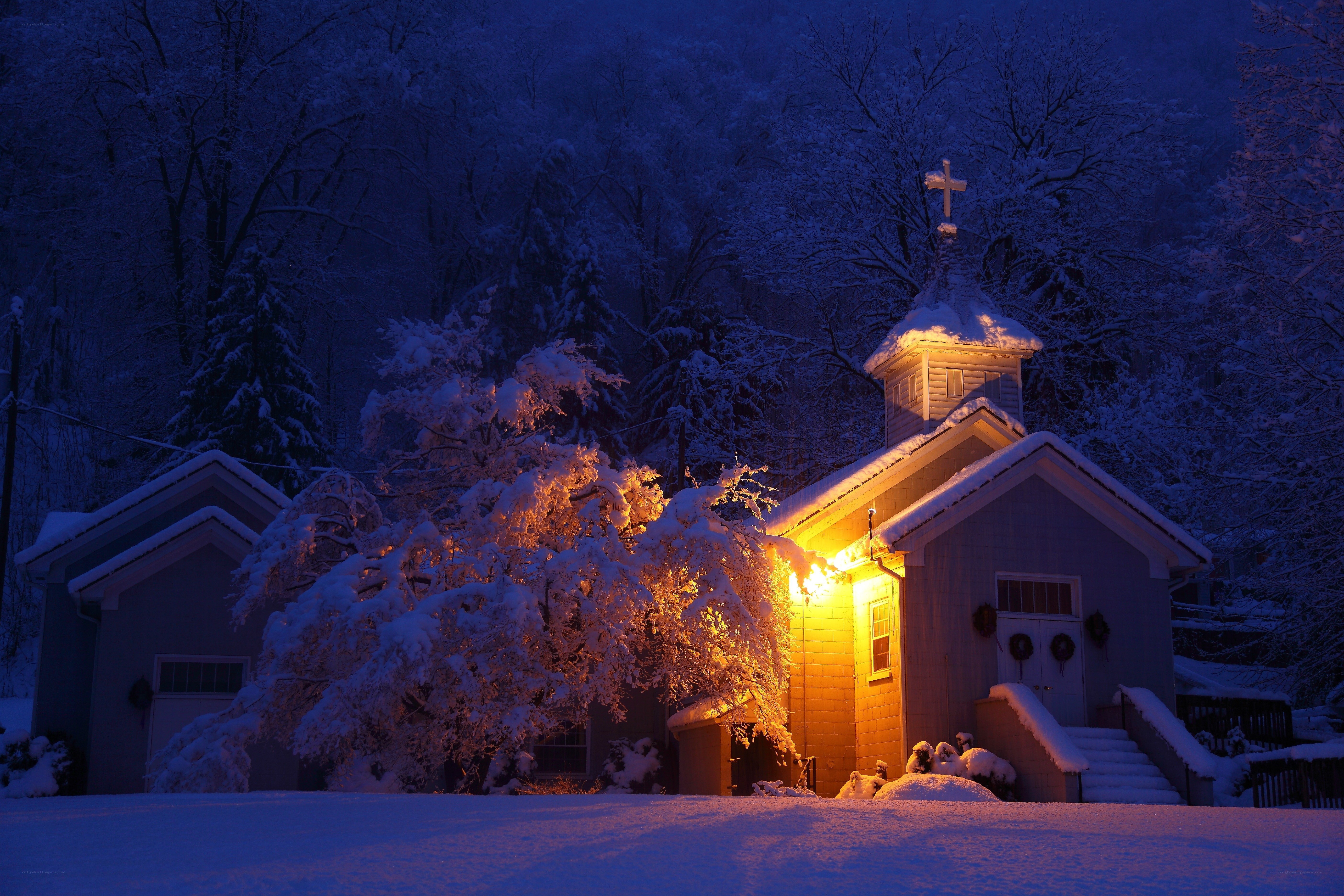Snowy church at night