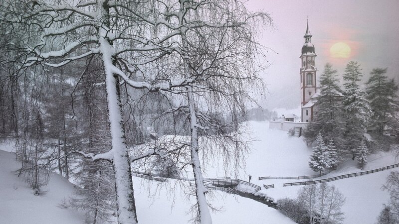 Snowy church at sunset