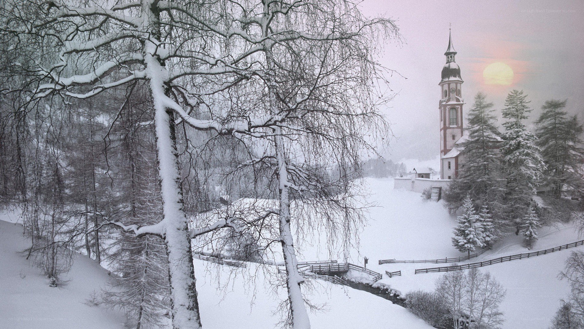 Snowy church at sunset
