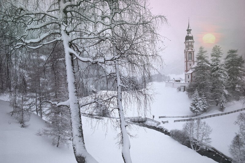 Snowy church at sunset