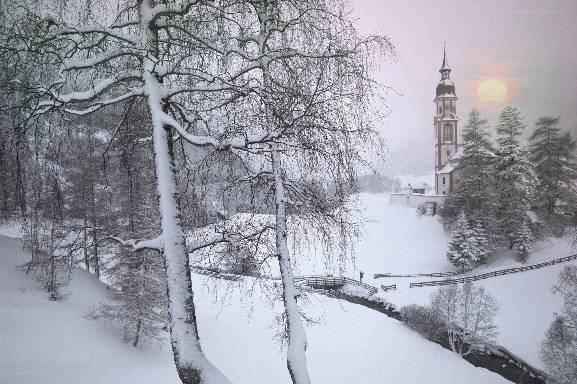 Snowy church at sunset