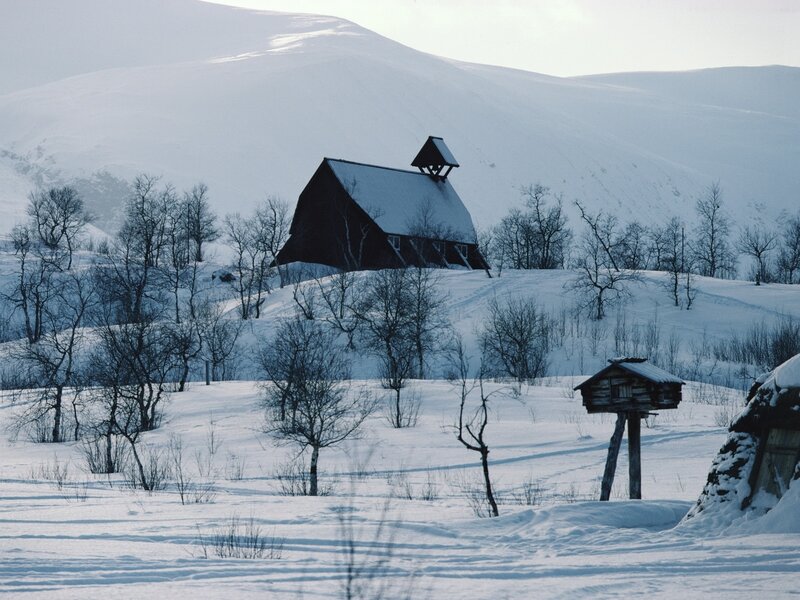 Snowy church in mountain landscape