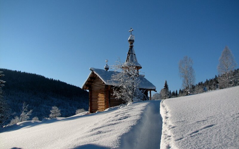 Snowy church in winter landscape