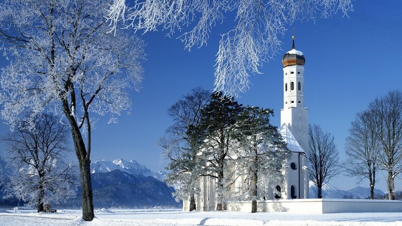 Snowy church in winter landscape