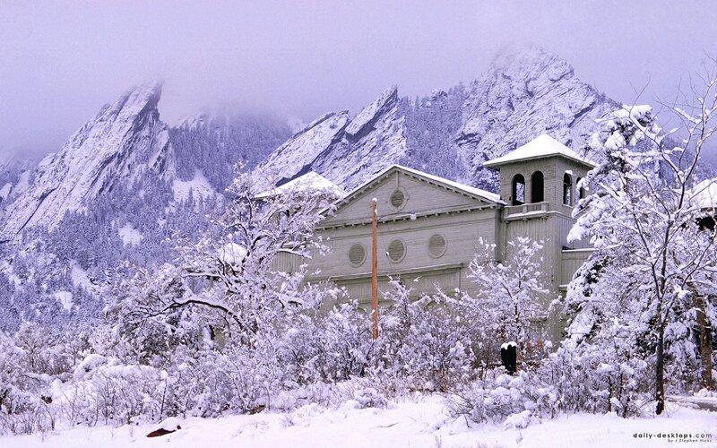 Snowy church with mountains