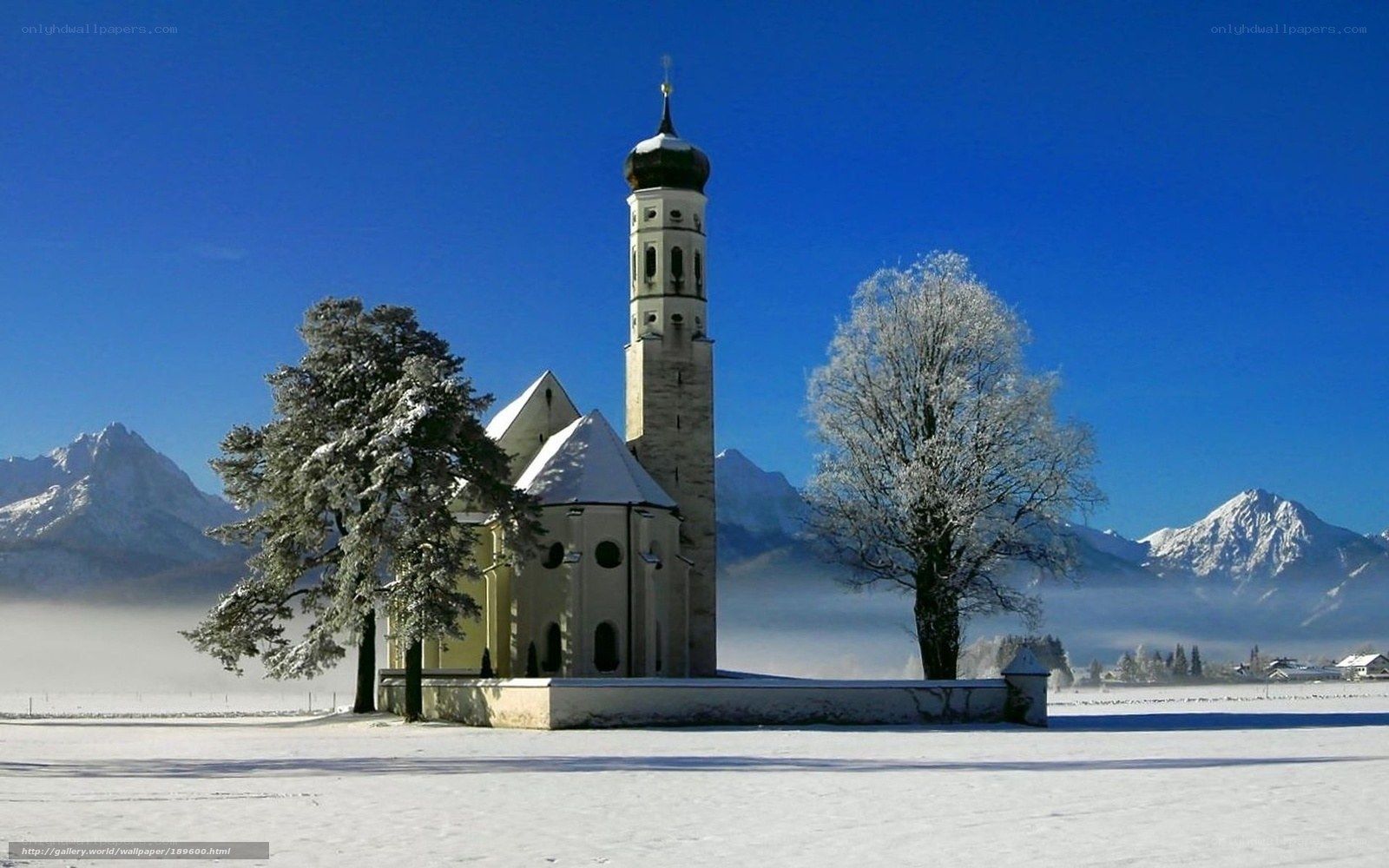 Snowy church with mountains