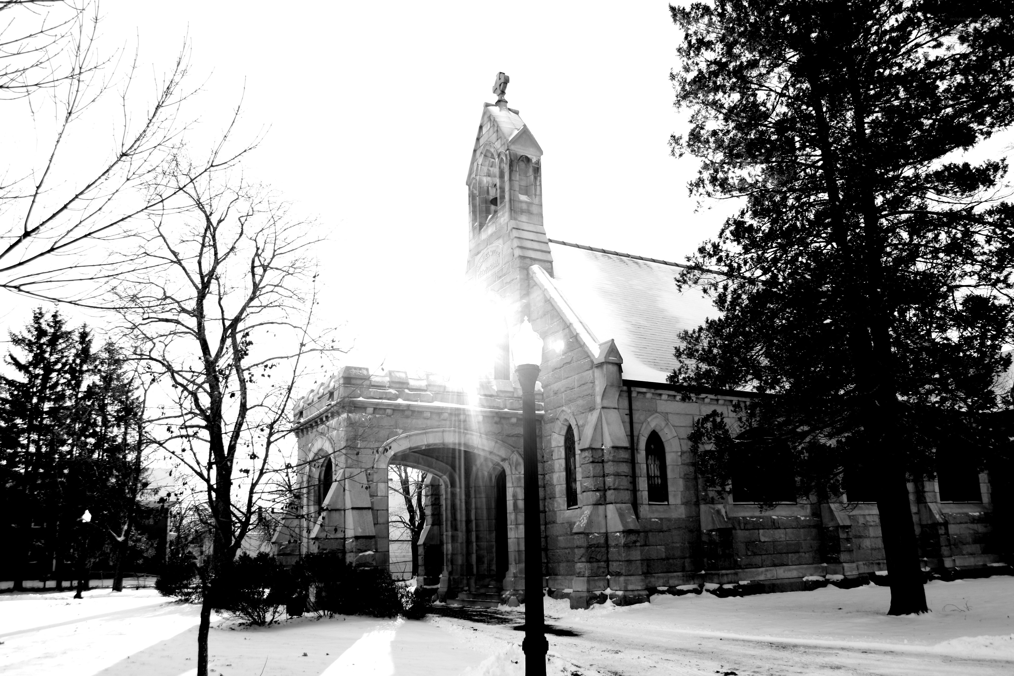 Snowy church with sun glare