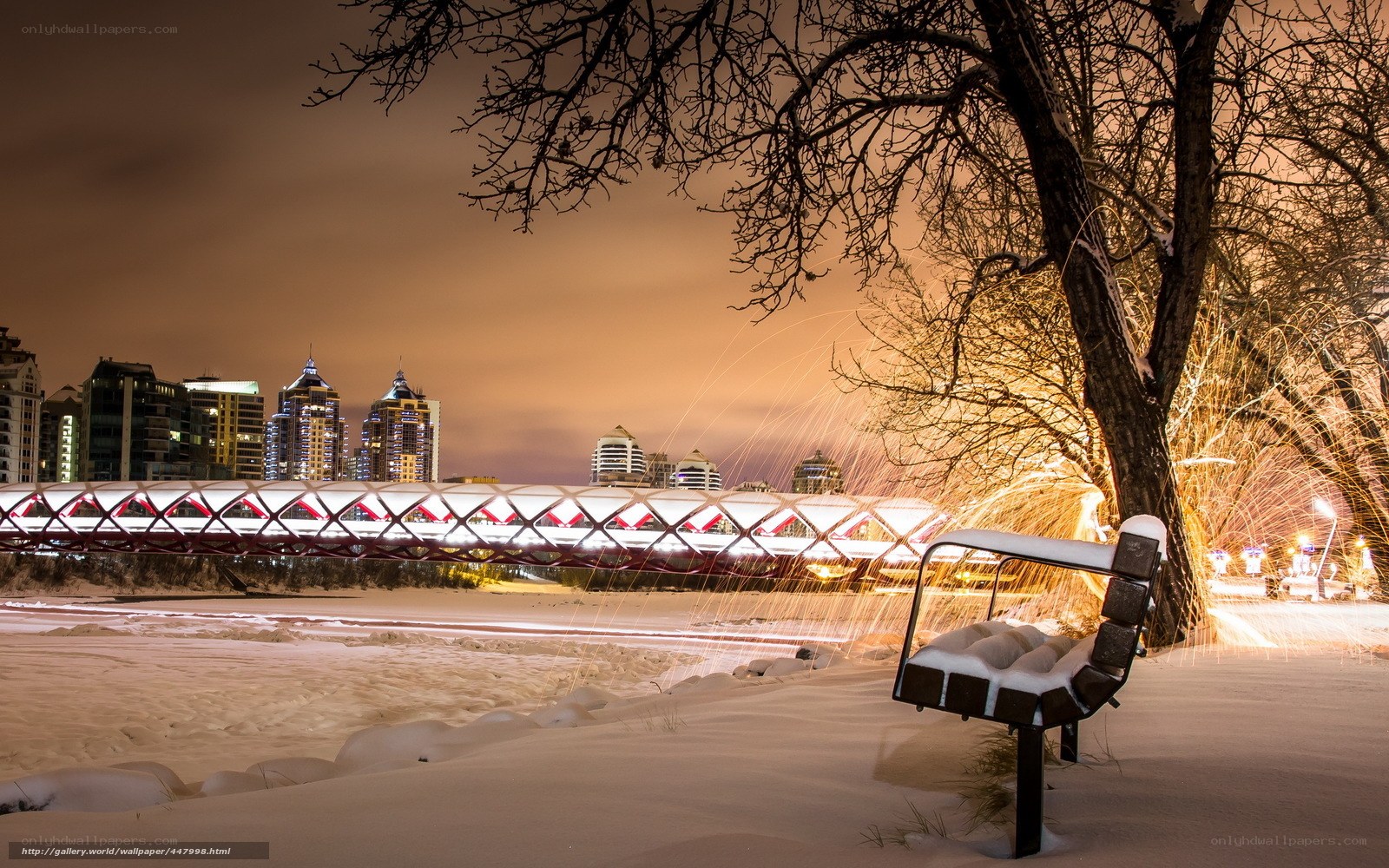 Snowy city bridge at night