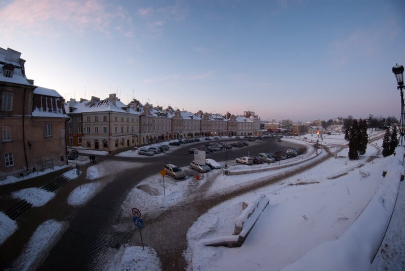 Snowy city square at dusk