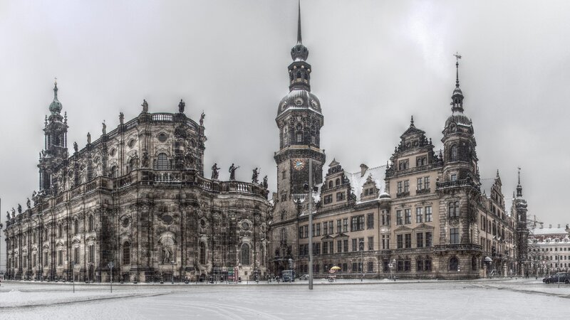 Snowy city square with historic buildings