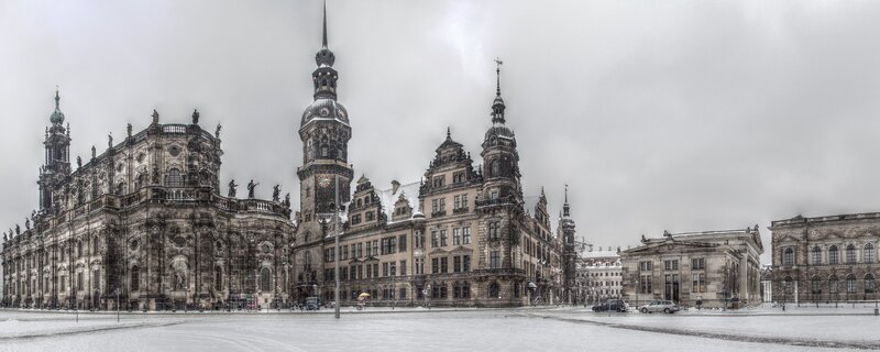 Snowy city square with historic buildings