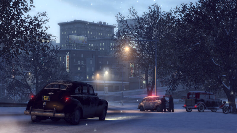 Snowy city street at night