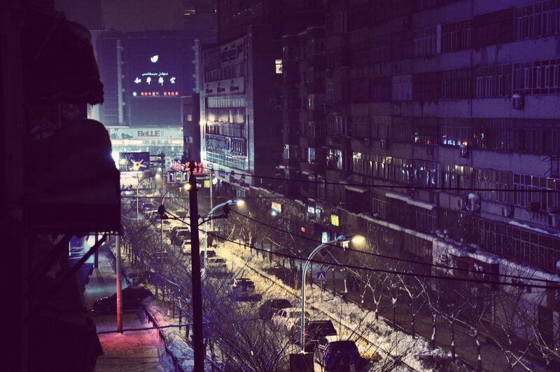 snowy city street at night