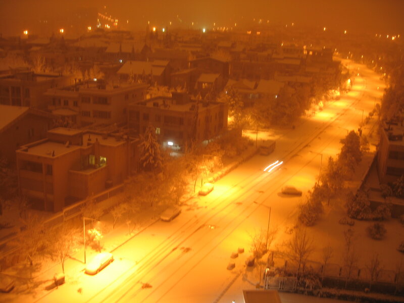 snowy city street at night