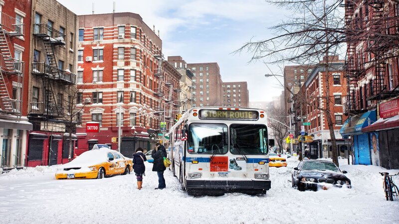 Snowy city street with bus
