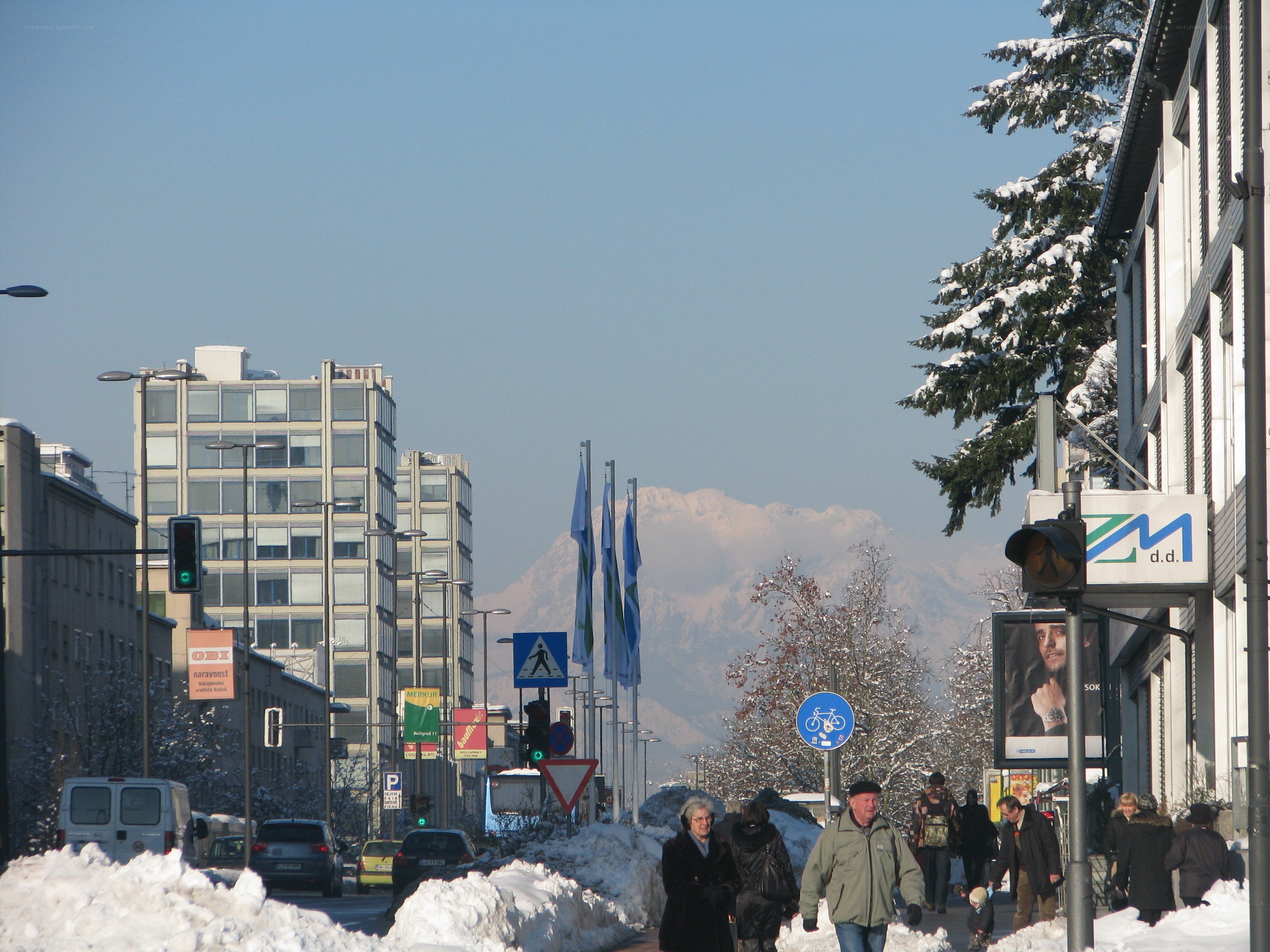 Snowy city street with mountains