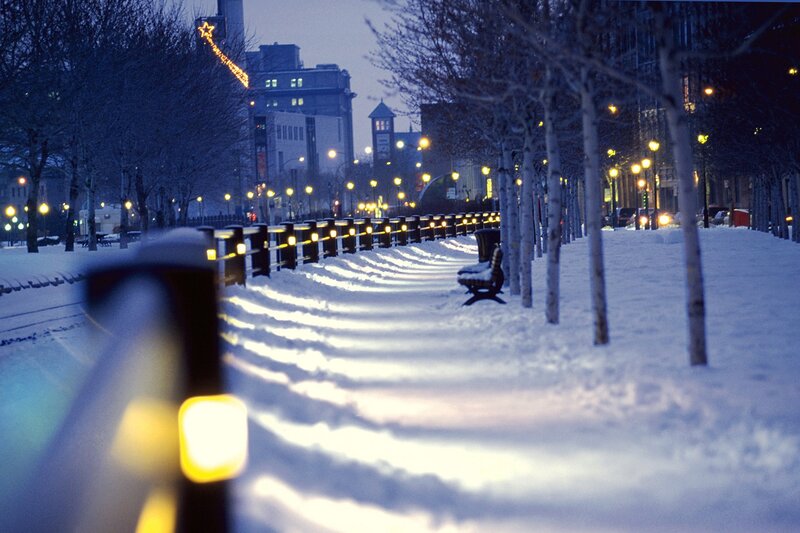 Snowy city walkway at dusk