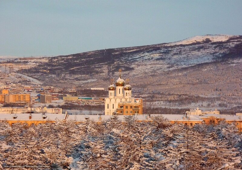Snowy city with church dome