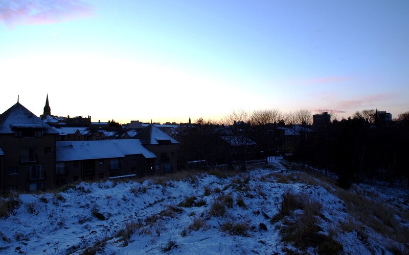 Snowy cityscape at dusk