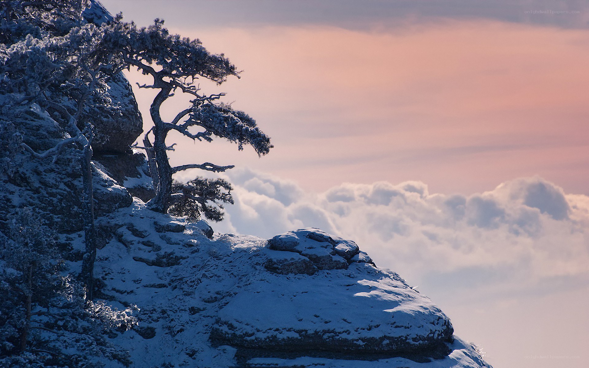 Snowy cliff at sunset