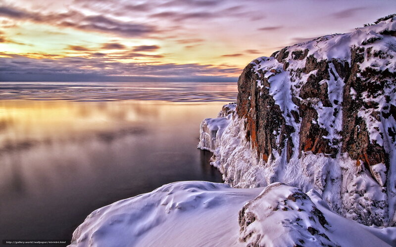 Snowy cliff at sunset