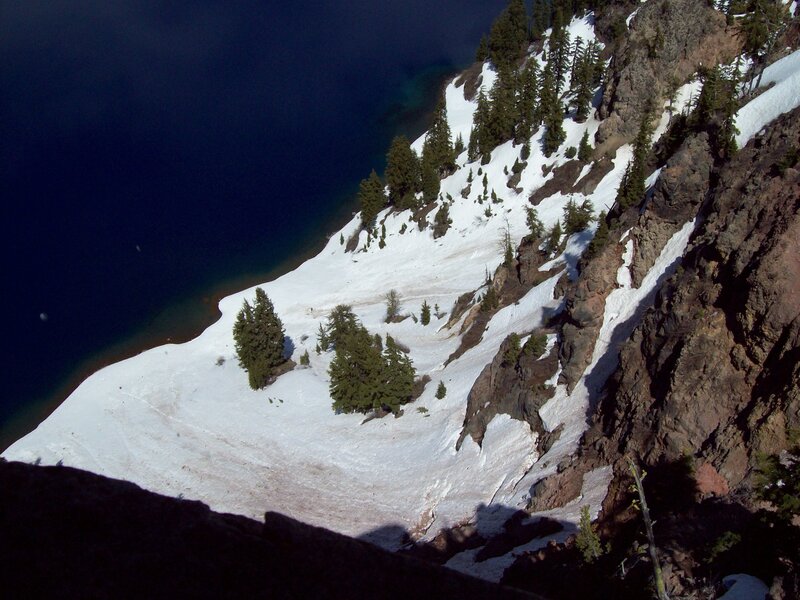 snowy cliff overlooking a lake