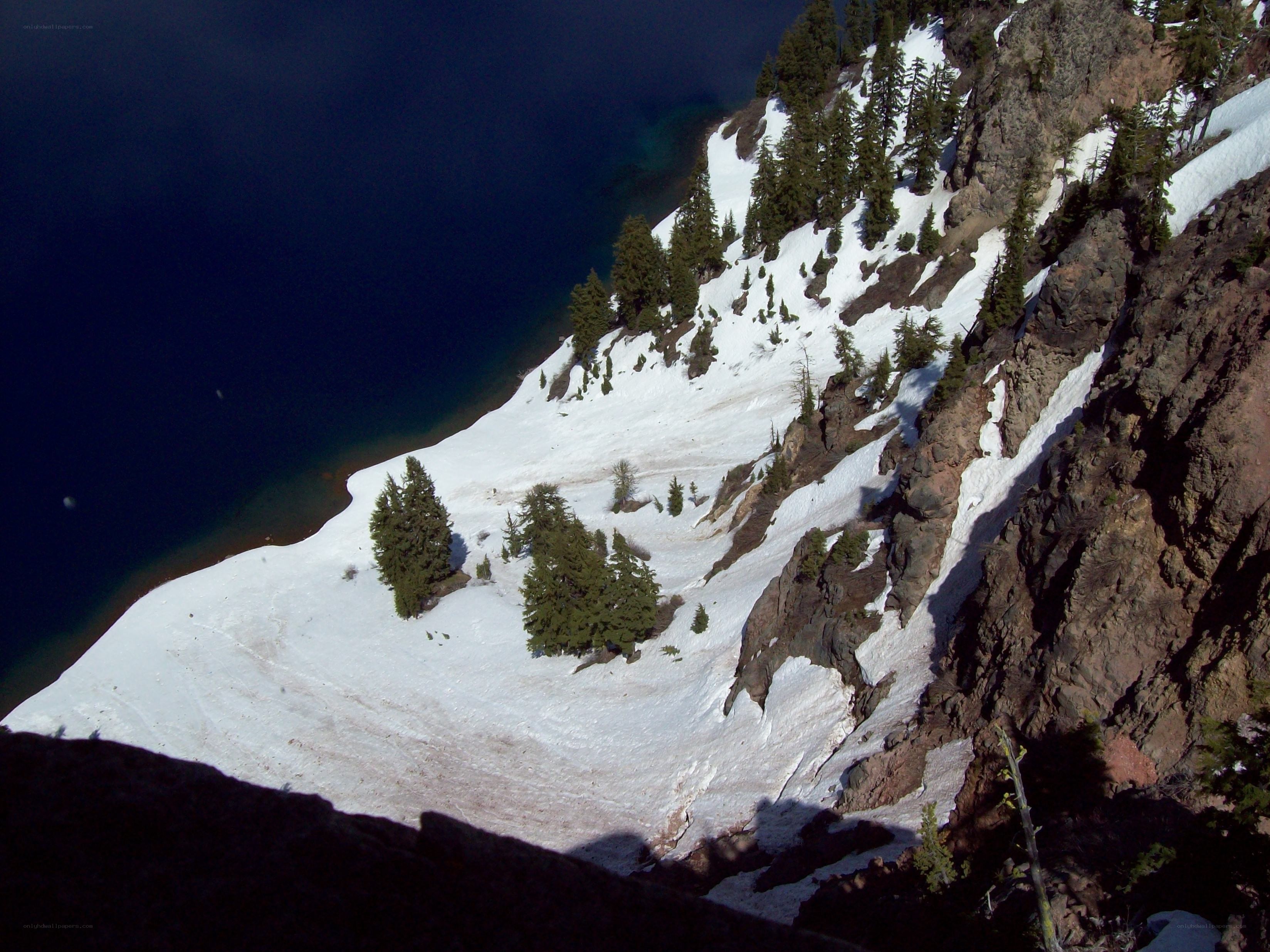 snowy cliff overlooking a lake