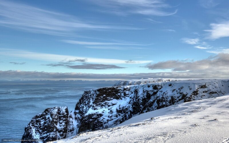 Snowy Cliffs Over Ocean