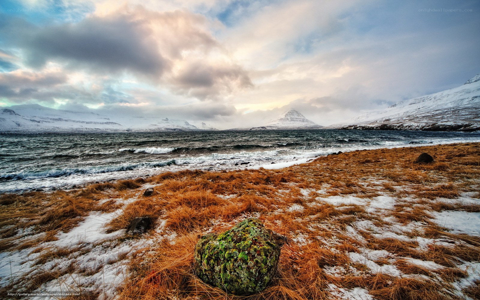 Snowy coastal landscape with mountain