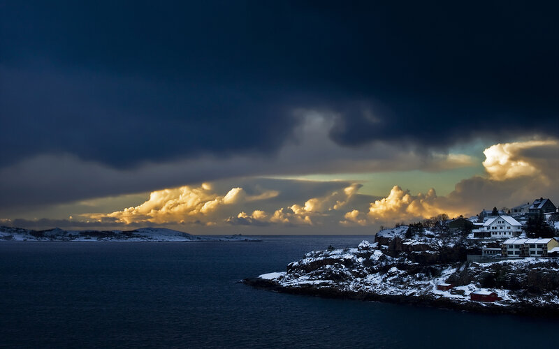Snowy coastal town at dusk