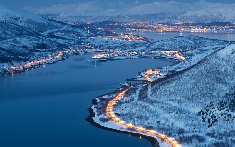 Snowy coastal town at dusk