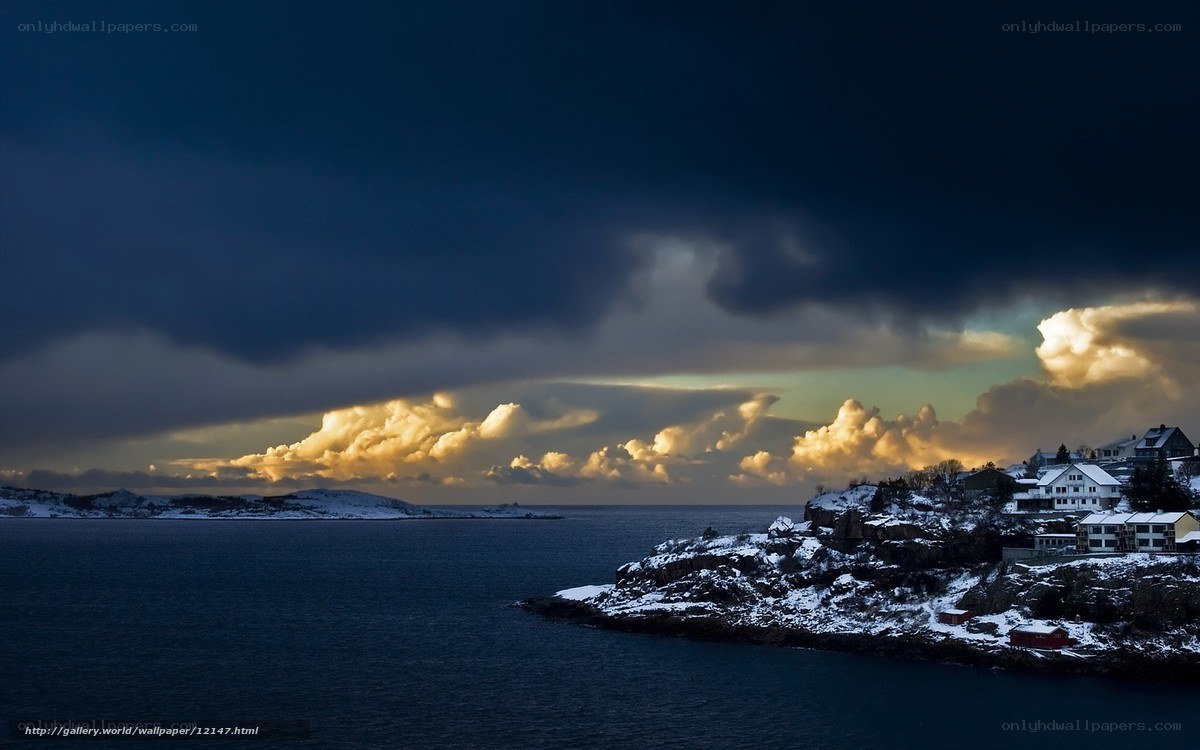 Snowy coastal town at sunset