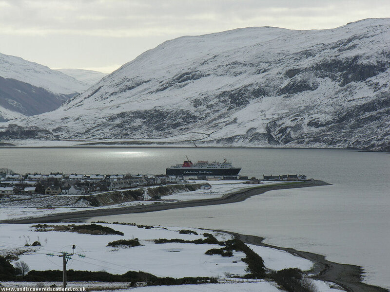 Snowy coastal village with ferry