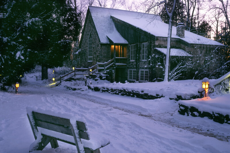 Snowy cottage at dusk
