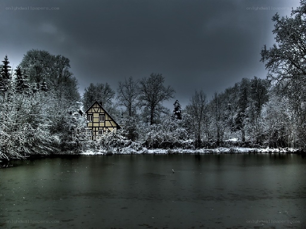 Snowy cottage by a lake