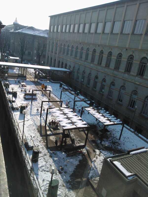 Snowy courtyard with modern shelters