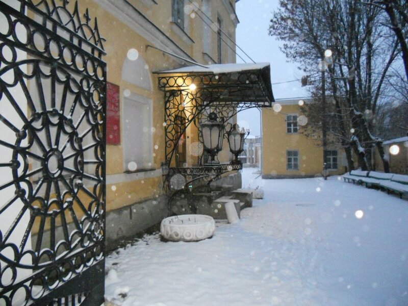 Snowy courtyard with ornate gate