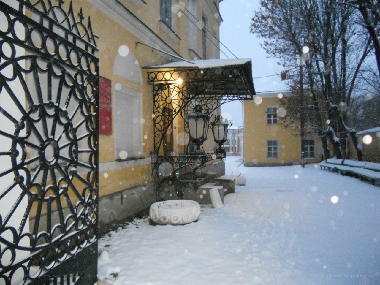 Snowy courtyard with ornate gate