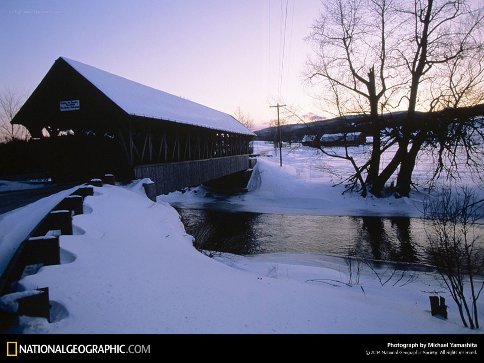 Snowy covered bridge at dusk