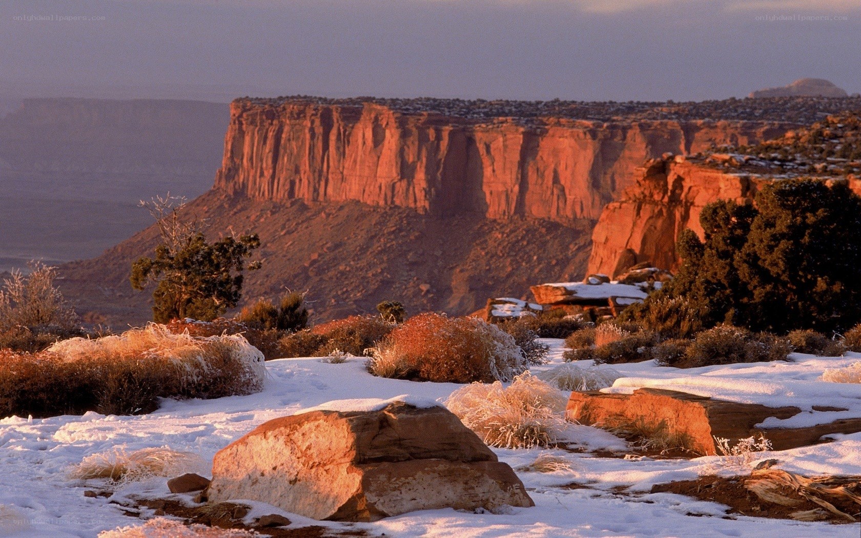 Snowy desert canyon at sunset