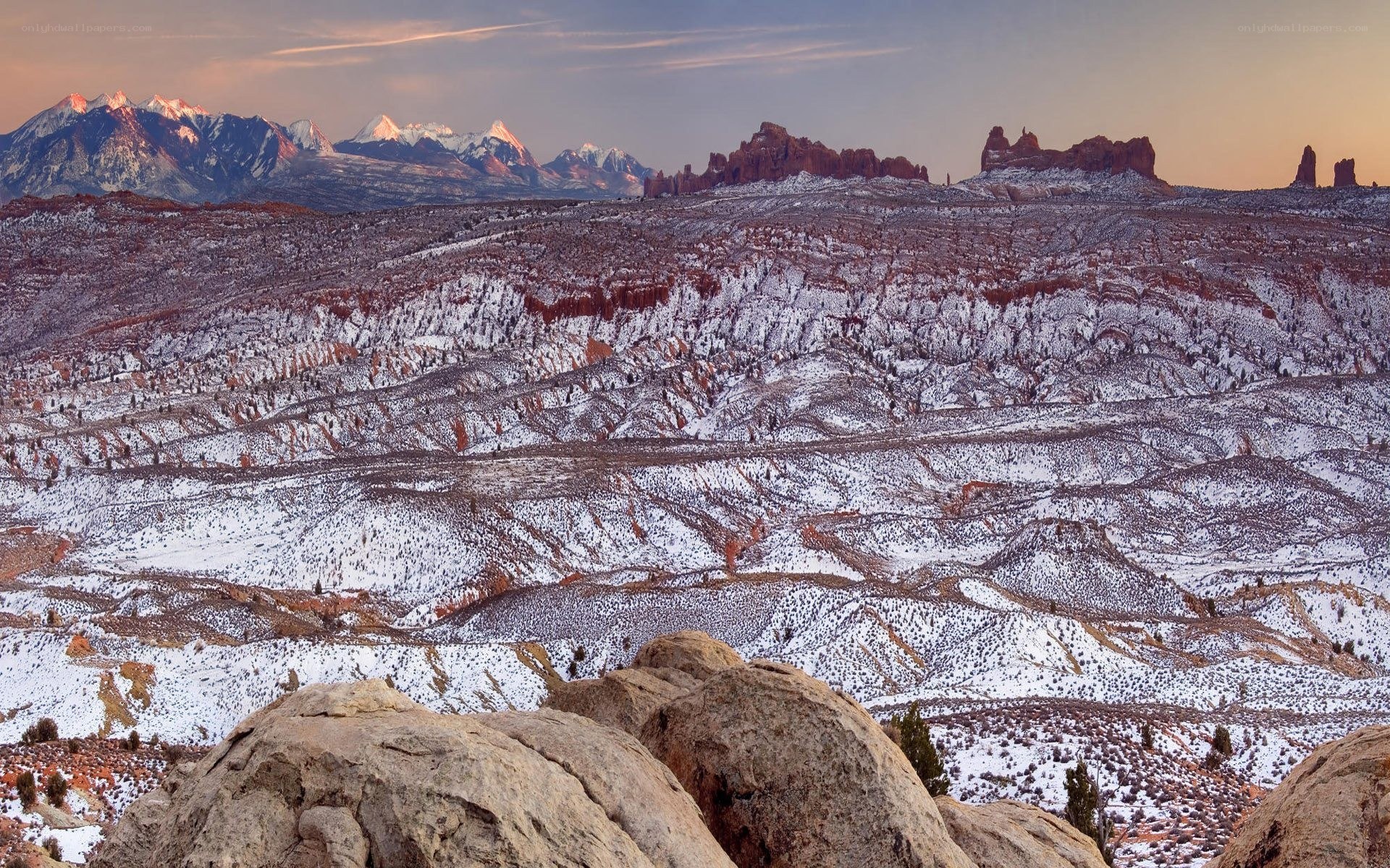 Snowy desert landscape at sunset
