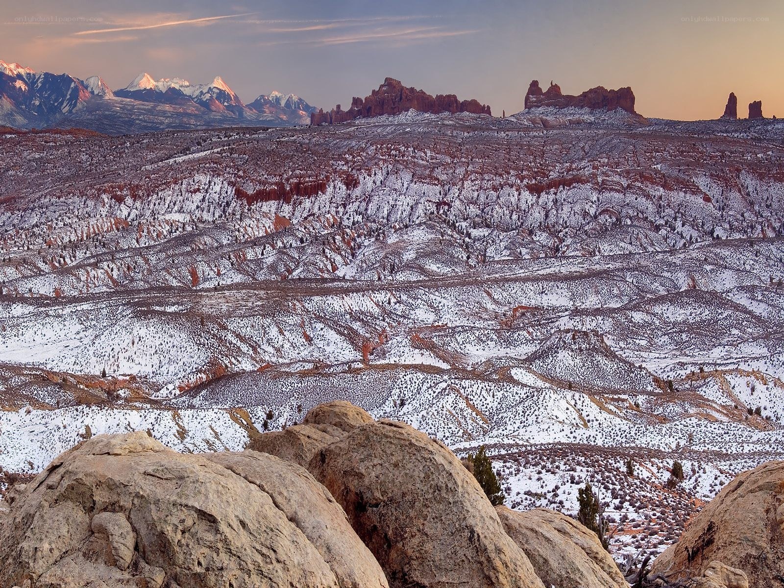 Snowy desert landscape at sunset